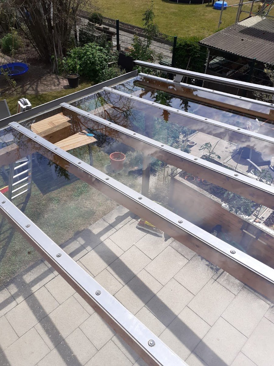 Terrassenüberdachung aus Glas von oben, darunter die Terrasse
